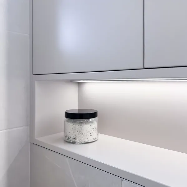 Platsbyggt badrumsskåp med öppen hylla och belysning